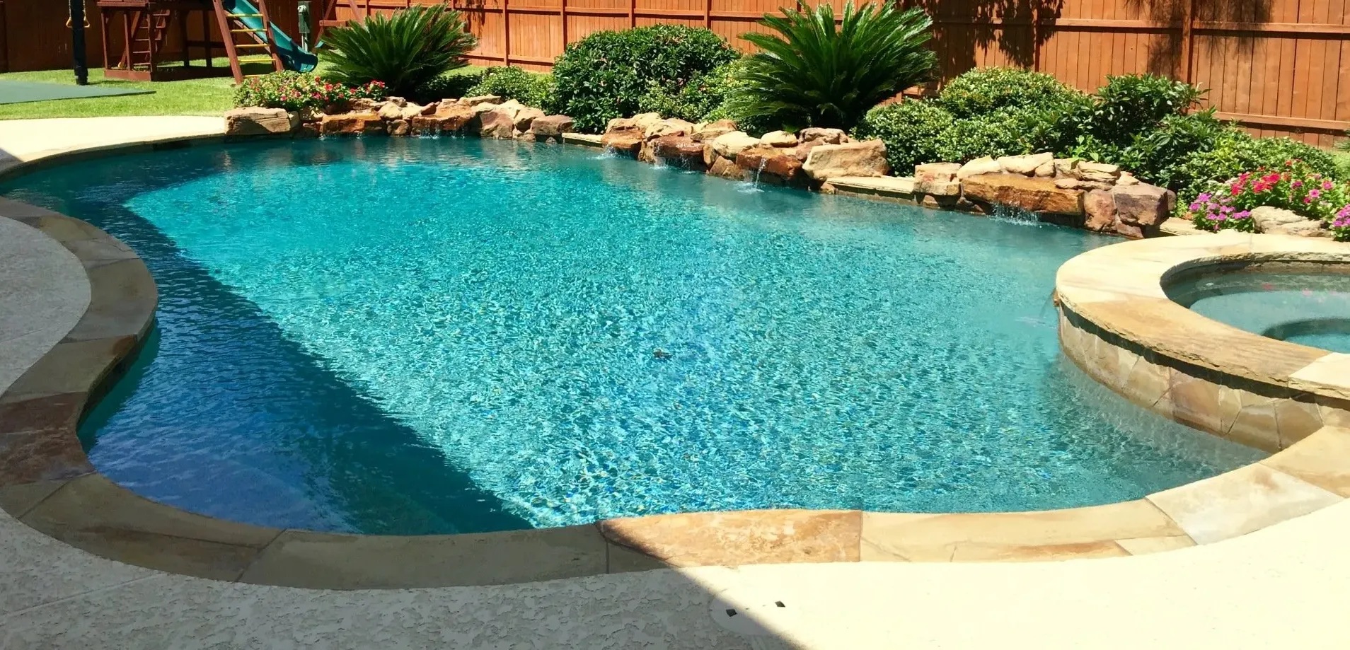 Unusually Shaped Pool with Various Stone Surrounds