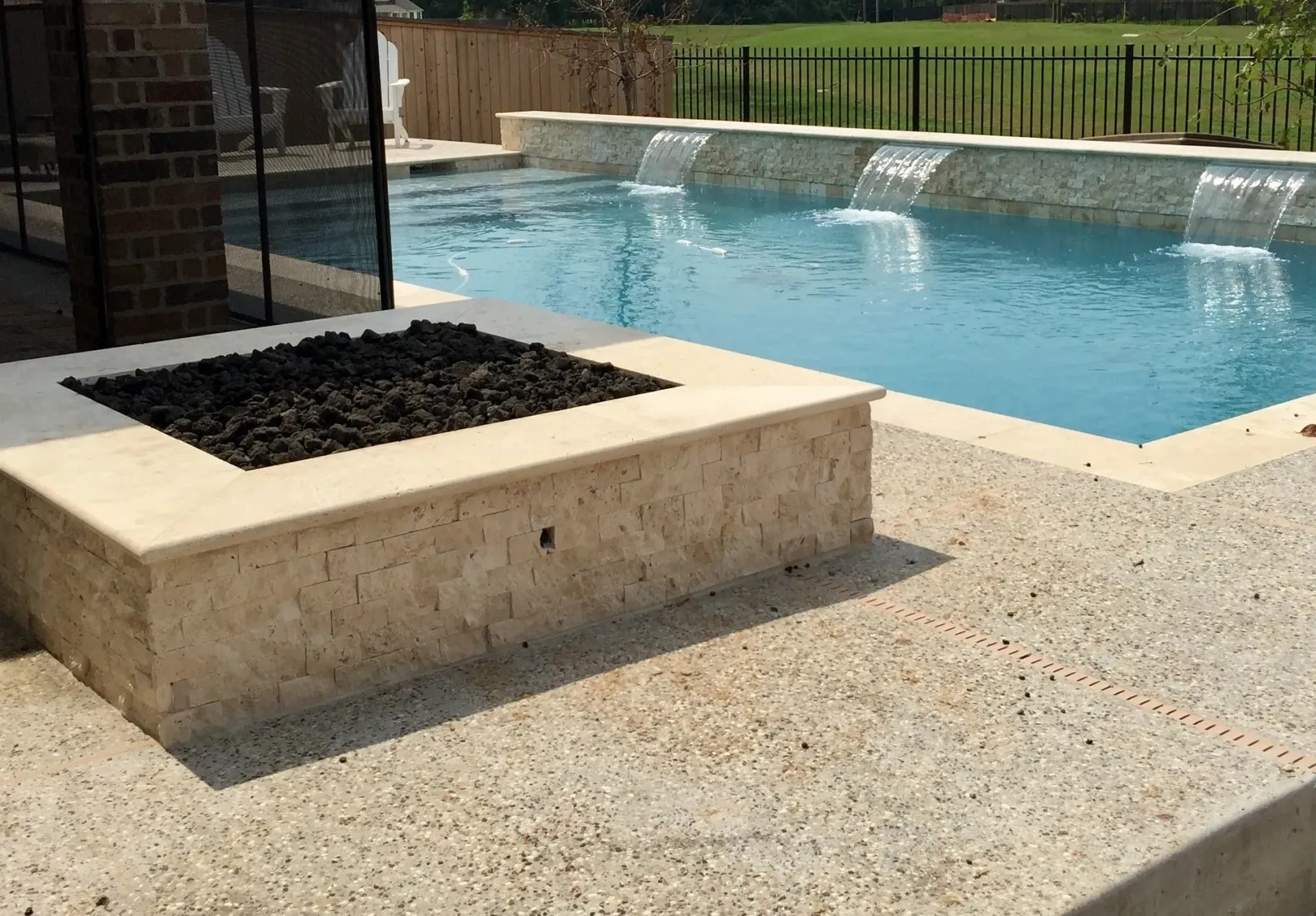 Firepit and Pool with stonework waterfalls